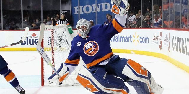 Robin Lehner #40 of the New York Islanders is tripped up against the Carolina Hurricanes in Game One of the Eastern Conference Second Round during the 2019 NHL Stanley Cup Playoffs at the Barclays Center on April 26, 2019 in the Brooklyn borough of New York City. (Photo by Bruce Bennett/Getty Images)