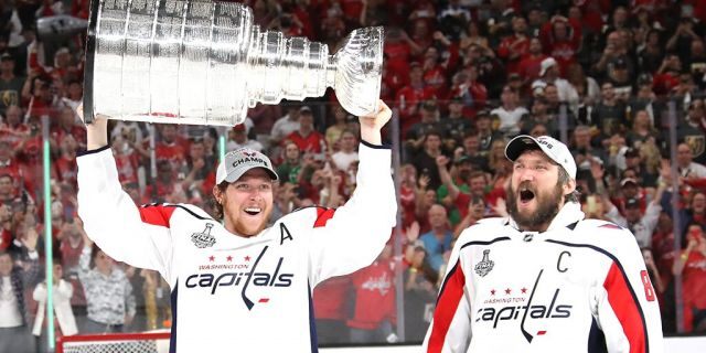 Alex Ovechkin #8 hands of the Stanley Cup to Nicklas Backstrom #19 of the Washington Capitals after their team's 4-3 win over the the Vegas Golden Knights in Game Five of the 2018 NHL Stanley Cup Final at T-Mobile Arena on June 7, 2018 in Las Vegas, Nevada. (Photo by Bruce Bennett/Getty Images)