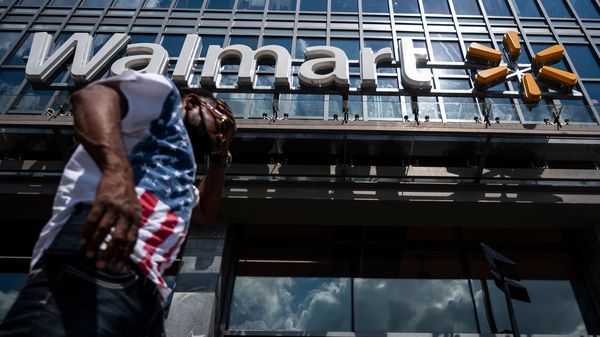 A man walks past a Walmart store in Washington, D.C. on July 15. Walmart said it was "confident" that its joint deal with Microsoft would satisfy both TikTok users and U.S. government regulators.