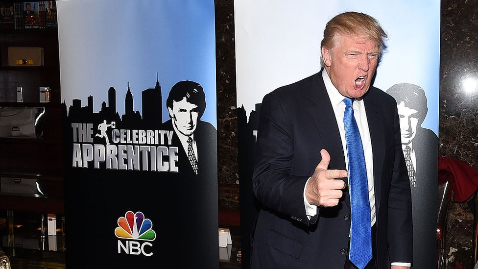 President Donald Trump posing at a red carpet event for the launch of The Celebrity Apprentice TV series in 2015