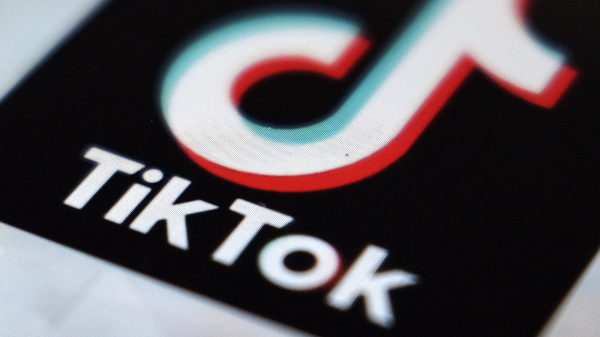 TikTok says it is banning all accounts that share content related to the QAnon conspiracy theory, hardening its previous policy on the far-right movement.