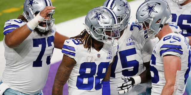 Dallas Cowboys wide receiver CeeDee Lamb (88) celebrates with teammates after catching a 4-yard touchdown pass during the first half of an NFL football game against the Minnesota Vikings, Sunday, Nov. 22, 2020, in Minneapolis. (AP Photo/Bruce Kluckhohn)