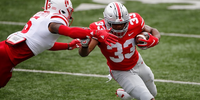 Nebraska defensive back Cam Taylor-Britt, left, forces Ohio State running back Master Teague out of bounds during the first half of an NCAA college football game Saturday, Oct. 24, 2020, in Columbus, Ohio. (AP Photo/Jay LaPrete)
