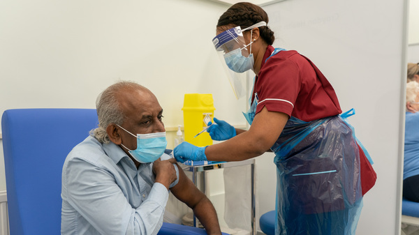A nurse prepares to administer a COVID-19 vaccine at Croydon University Hospital in London.