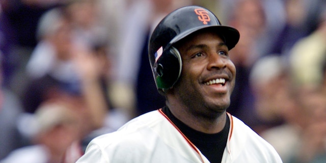 San Francisco Giants' Barry Bonds smiles as he begins to round the bases after he hit his 73rd home run of the season, against the Los Angeles Dodgers in a baseball game in San Francisco on Oct. 7, 2001. (AP Photo/Eric Risberg, File)