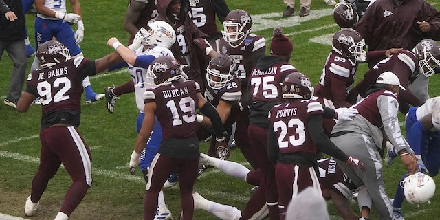 Members of Tulsa and Mississippi State fight after time runs out in the Armed Forces Bowl NCAA college football game Thursday, Dec. 31, 2020, in Fort Worth, Texas. (AP Photo/Jim Cowsert)