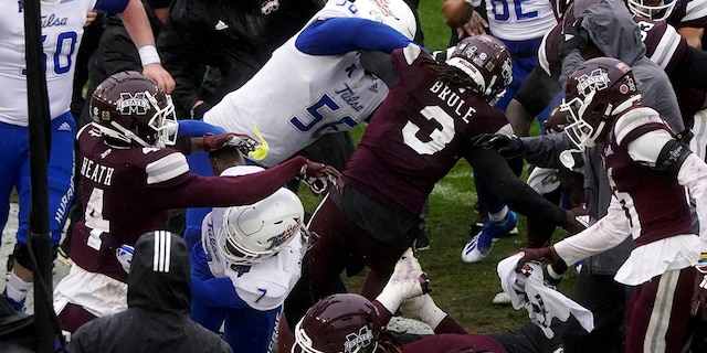 Members of Tulsa and Mississippi State fight after time runs out in the Armed Forces Bowl NCAA college football game Thursday, Dec. 31, 2020, in Fort Worth, Texas. (AP Photo/Jim Cowsert)