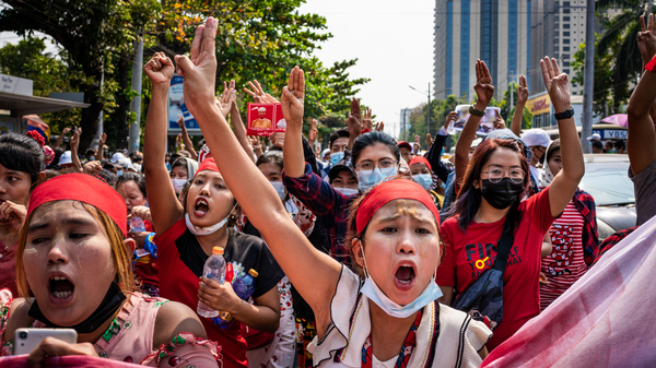 People make three-finger salutes during an anti-coup march on Saturday in Yangon, Myanmar.