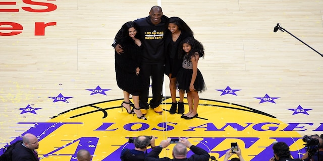 FILE - In this April 13, 2016, file photo, Los Angeles Lakers' Kobe Bryant poses for pictures with his wife Vanessa, left, and daughters Natalia, second from right, and Gianna as they stand on the court after an NBA basketball game against the Utah Jazz, in Los Angeles. Kobe Bryant's legacy may be stronger than ever. Tuesday, Jan. 26, 2021, marks the anniversary of the crash that took the lives of Bryant, Gianna and seven other people. (AP Photo/Mark J. Terrill, File)