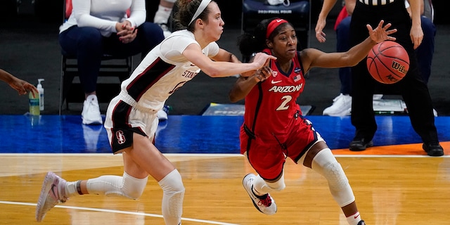 Arizona guard Aari McDonald (2) drives past Stanford guard Lexie Hull, left, during the second half of the championship game in the women's Final Four NCAA college basketball tournament, Sunday, April 4, 2021, at the Alamodome in San Antonio. (AP Photo/Eric Gay)