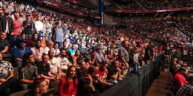 Fans attend a UFC 261 mixed martial arts event Saturday, April 24, 2021, in Jacksonville, Fla. The sold-out event touted as the first full-capacity sporting event held indoors in more than a year drew a star-studded crowd. (Associated Press)