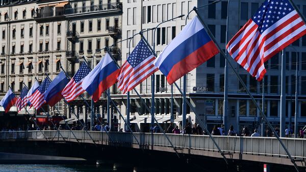U.S. and Russian flags fly on the Mont-Blanc bridge on the eve of a US-Russia summit on Tuesday in Geneva. A former intelligence operative says agencies are in high gear.