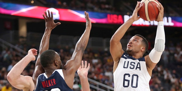 Team White guard Jalen Brunson (60) goes up for a shot under pressure from Team Blue guard Kemba Walker (26) during the first half of the U.S. men's basketball team's scrimmage in Las Vegas, Friday, Aug. 9, 2019. (Associated Press)