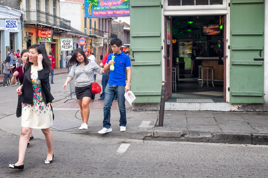 tourists drinking hand grenade cocktail in new orleans