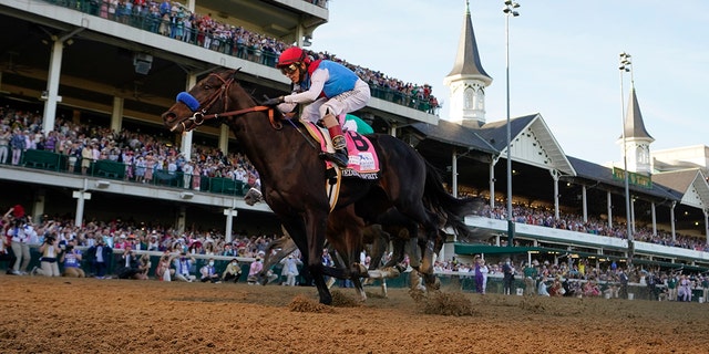 FILE - John Velazquez riding Medina Spirit crosses the finish line to win the 147th running of the Kentucky Derby at Churchill Downs in Louisville, Ky., in this Saturday, May 1, 2021, file photo. Bob Baffert’s lawyer said Wednesday, June 2, 2021, that a split-sample test of Kentucky Derby winner Medina Spirit came back positive for the presence of the steroid betamethasone, which could lead to the horse’s disqualification and discipline for the Hall of Fame trainer.  (AP Photo/Jeff Roberson, File)