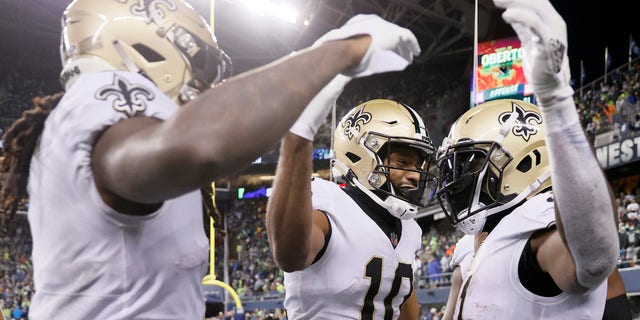 SEATTLE, WASHINGTON - OCTOBER 25: Alvin Kamara #41 of the New Orleans Saints celebrates a touchdown with Tre'Quan Smith #10 and Marquez Callaway #1 during the first half against the Seattle Seahawks at Lumen Field on October 25, 2021 in Seattle, Washington. (Photo by Steph Chambers/Getty Images)