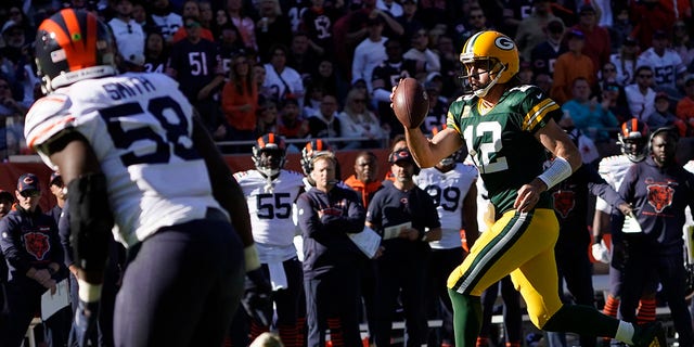 Green Bay Packers quarterback Aaron Rodgers pulls the ball down and runs for a touchdown during the second half of an NFL football game against the Chicago Bears Sunday, Oct. 17, 2021, in Chicago. (AP Photo/David Banks)