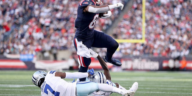 Jonnu Smith (81) of the New England Patriots runs with the ball against Trevon Diggs (7) of the Dallas Cowboys in the first quarter at Gillette Stadium Oct. 17, 2021 in Foxborough, Mass.