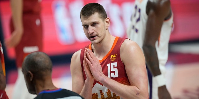 Denver Nuggets center Nikola Jokic (15) argues for a call with referee Rodney Mott (71) in the first half of Game 4 of an NBA second-round playoff series against the Phoenix Suns, Sunday, June 13, 2021, in Denver.