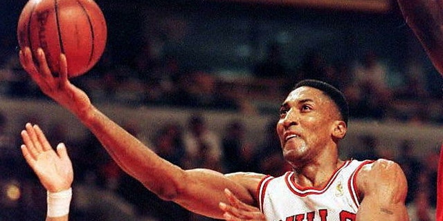 Scottie Pippen of the Chicago Bulls drives past Tracy Murry of the Washington Bullets during the first half of game two in their NBA playoff game April 27, 1997, at the United Center in Chicago, Illinois.