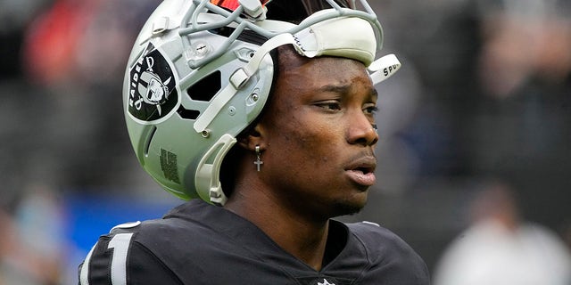 FILE - Las Vegas Raiders wide receiver Henry Ruggs III walks on the field before an NFL football game against the Chicago Bears, Oct. 10, 2021, in Las Vegas. Police in Las Vegas said Ruggs is facing a driving under the influence charge after a fiery vehicle crash early Tuesday, Nov. 2, 2021, that left a woman dead and Ruggs and his female passenger injured.