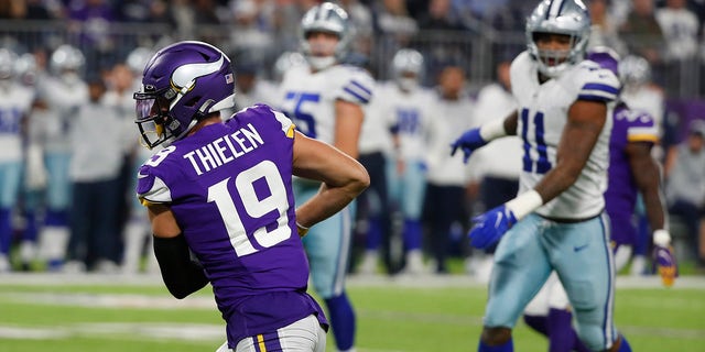 Minnesota Vikings wide receiver Adam Thielen (19) catches a 20-yard touchdown pass ahead of Dallas Cowboys outside linebacker Micah Parsons (11) during the first half of an NFL football game, Sunday, Oct. 31, 2021, in Minneapolis.