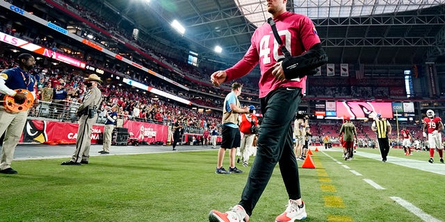 Injured Arizona Cardinals defensive end J.J. Watt walks off the field after an NFL football game against the Carolina Panthers on Nov. 14, 2021, in Glendale, Arizona.