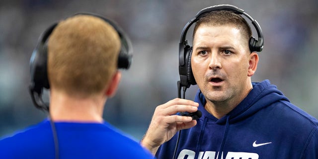 Head Coach Joe Judge talks with offensive coordinator Jason Garrett of the New York Giants during a game against the Dallas Cowboys at AT&amp;T Stadium on October 10, 2021 in Arlington, Texas.  The Cowboys defeated the Giants 44-20.  