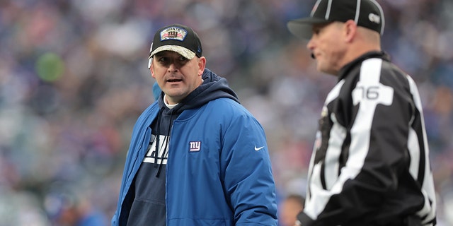 Nov 28, 2021; East Rutherford, New Jersey, USA; New York Giants head coach Joe Judge look back as side judge Alan Eck (76) during the second half against the Philadelphia Eagles at MetLife Stadium.