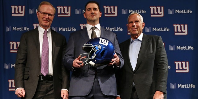 New York Giants new head coach Joe Judge, center, poses for photographs with team CEO John Mara, left, chairman and executive vice president Steve Tisch, right, after a news conference at MetLife Stadium on January 9, 2020 in East Rutherford, New Jersey.