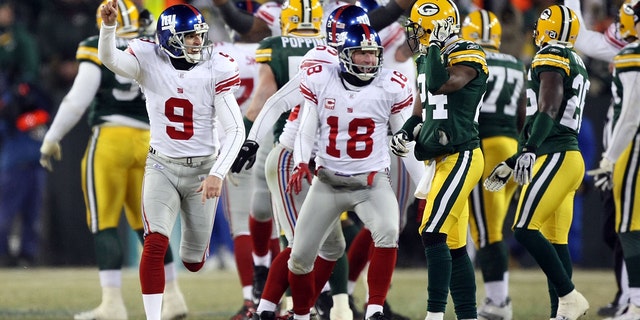 Kicker Lawrence Tynes #9 of the New York Giants celebrates after kicking the game winning 47-yard field goal to win the NFC championship game against the Green Bay Packers on Jan. 20, 2008 at Lambeau Field in Green Bay, Wisconsin.   The Giants defeated the Packers 23-20 in overtime to advance to the Superbowl XLII.