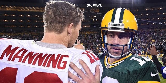 Aaron Rodgers of the Green Bay Packers speaks with Eli Manning of the New York Giants following a game at Lambeau Field on Oct. 9, 2016 in Green Bay, Wisconsin.