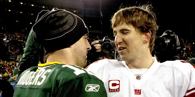Aaron Rodgers of the Green Bay Packers is congratulated by Eli Manning of the New York Giants after their game at Lambeau Field on Dec. 26, 2010 in Green Bay, Wisconsin. 