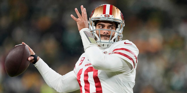 Jimmy Garoppolo of the San Francisco 49ers warms up before an NFC divisional playoff game against the Green Bay Packers at Lambeau Field Jan. 22, 2022, in Green Bay, Wis.