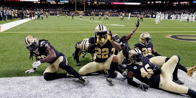 New Orleans Saints defensive back Chauncey Gardner-Johnson (22) celebrates his interception with teammates in the second half of an NFL football game against the Carolina Panthers in New Orleans, Sunday, Jan. 2, 2022. The Saints won 18-10.