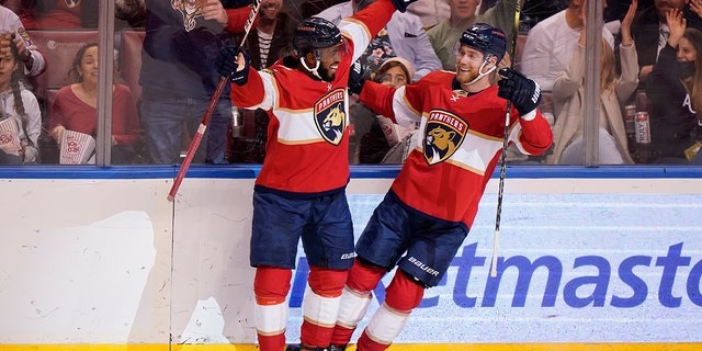 Florida Panthers left wing Anthony Duclair, left, helps center Sam Bennett celebrate his goal during the second period of an NHL hockey game against the Dallas Stars, Friday, Jan. 14, 2022, in Sunrise, Fla.