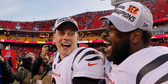 Quarterback Joe Burrow of the Cincinnati Bengals and defensive tackle Tyler Shelvin celebrate following the Bengals' overtime win against the Kansas City Chiefs in the AFC Championship Game. 