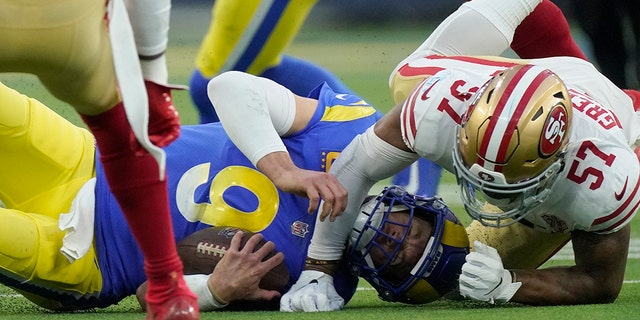 The San Francisco 49ers' Dre Greenlaw (57) stops the Los Angeles Rams' Matthew Stafford during the first half of the NFC Championship NFL football game Sunday, Jan. 30, 2022, in Inglewood, California.