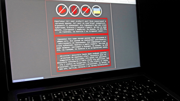 A laptop screen displays a warning message in Ukrainian, Russian and Polish that appeared on the official website of the Ministry of Foreign Affairs of Ukraine after a massive cyberattack on Friday.