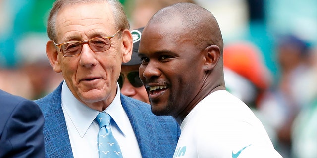 FILE -Miami Dolphins head coach Brian Flores talks to Miami Dolphins owner Stephen M. Ross during practice before an NFL football game against the New York Jets, Sunday, Nov. 3, 2019, in Miami Gardens, Fla.
