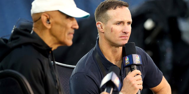 NBC commentator Drew Brees looks on before a game between the Tampa Bay Buccaneers and New England Patriots at Gillette Stadium Oct. 3, 2021, in Foxborough, Mass.
