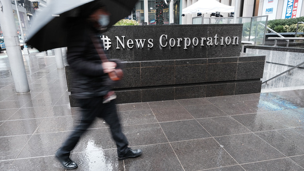 News Corp. announced on Friday that it suffered a cyberattack that was discovered in January. Here, a person walks by the global media company