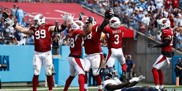 Arizona Cardinals defensive end J.J. Watt (99) celebrates after teammate Corey Peters, third from left, recovered a Tennessee Titans fumble in the first half of an NFL football game Sunday, Sept. 12, 2021, in Nashville, Tenn.