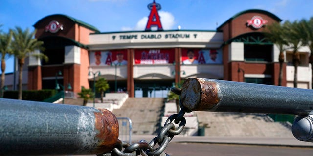 The main parking lot at the Los Angeles Angels Tempe Diablo Stadium remains closed as pitchers and catchers are not starting spring training workouts as scheduled as the Major League Baseball lockout enters its 77th day and will prevent pitchers and catchers from taking the field for the first time since October in Tempe, Ariz., Wednesday, Feb. 16, 2022. (AP Photo/Ross D. Franklin)