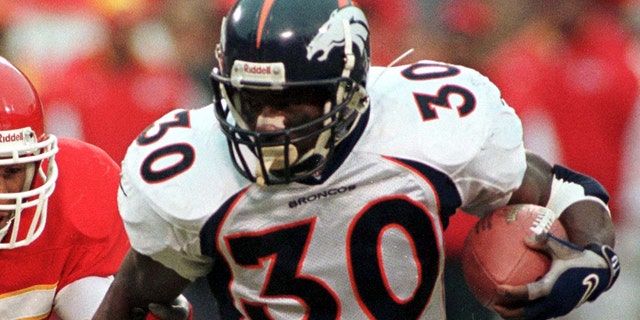 The Denver Broncos' Terrell Davis pulls away from the Kansas City Chiefs' Reggie Tongue during second-quarter action in an NFL playoff game.