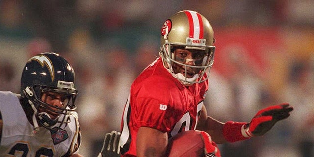 San Francisco 49ers wide receiver Jerry Rice (right) runs past the San Diego Chargers  to score a first-quarter touchdown Jan. 29, 1995, during Super Bowl XXIX at Joe Robbie Stadium in Miami. The touchdown was the earliest scored in Super Bowl history at 1:24 into the game.