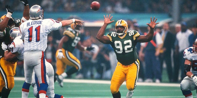 Drew Bledsoe (11) of the New England Patriots throws a pass while under pressure from Reggie White (92) of the Green Bay Packers during Super Bowl XXXI, Jan. 26, 1997, at the Louisiana Superdome in New Orleans, Louisiana. The Packers won the game 35-21.