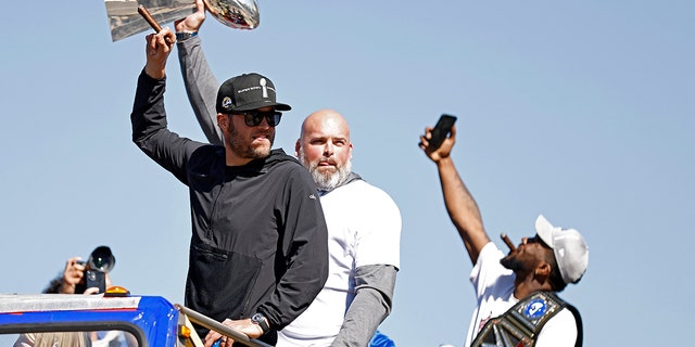 Matthew Stafford of the Los Angeles Rams (L) and Andrew Whitworth celebrate during the Super Bowl LVI Victory Parade on Feb. 16, 2022 in Los Angeles, California.