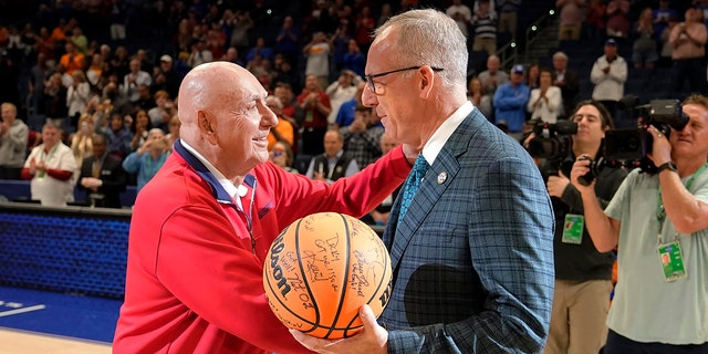ESPN broadcaster Dick Vitale, left, meets with SEC commissioner Greg Stankey before an NCAA college basketball between Texas A&amp;amp;M and Arkansas at the Southeastern Conference tournament, Saturday, March 12, 2022, in Tampa, Fla. 