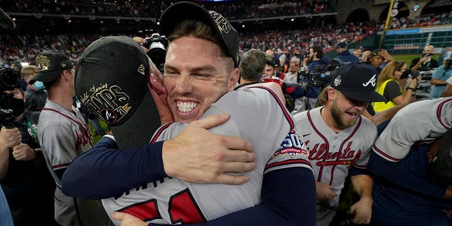 Atlanta Braves relief pitcher Will Smith, left, and first baseman Freddie Freeman celebrate after winning baseball's World Series in Game 6 against the Houston Astros Tuesday, Nov. 2, 2021, in Houston. The Braves won 7-0.